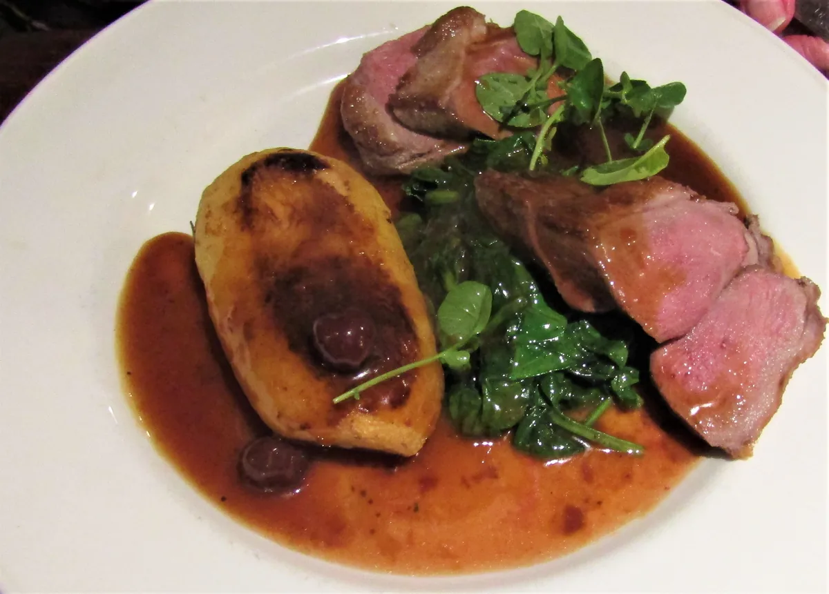Duck breast with cherry sauce, fondant potato and greens